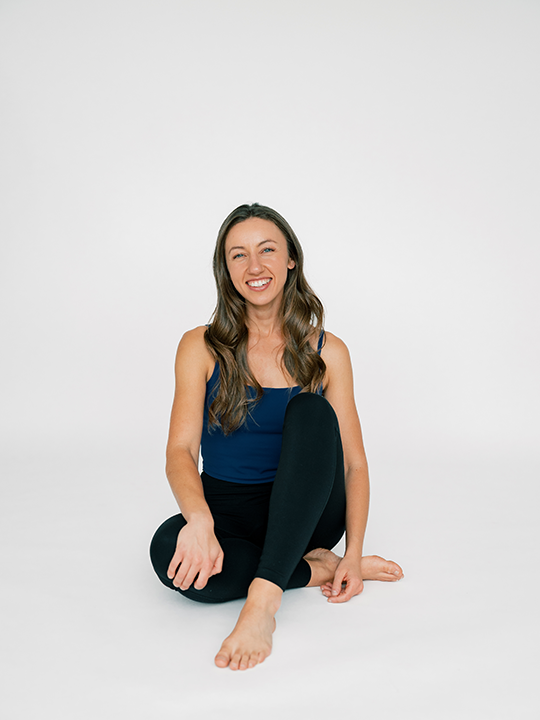 Studio Flo Pilates Instructor Emily Bosworth in dark exercise apparel