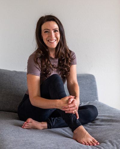 Jennie Groom sits on a couch