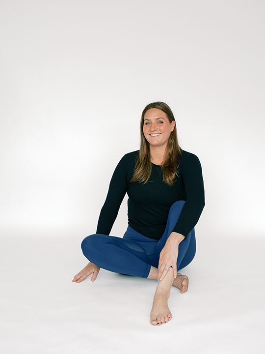 Studio Flo Pilates Instructor Kristen Karlin in dark exercise apparel