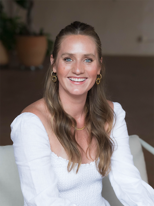 Studio Flo Pilates Instructor Kristen Karlin in a white outfit
